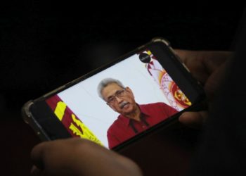 Ένα άτομο παρακολουθεί από το κινητό του διάγγελμα του προέδρου της Σρι Λάνκα, Γκοταμπάγια Ρατζαπάκσα, στις 11 Μαΐου 2022 (φωτ. αρχείου:  EPA / Chamila Karunarathne)