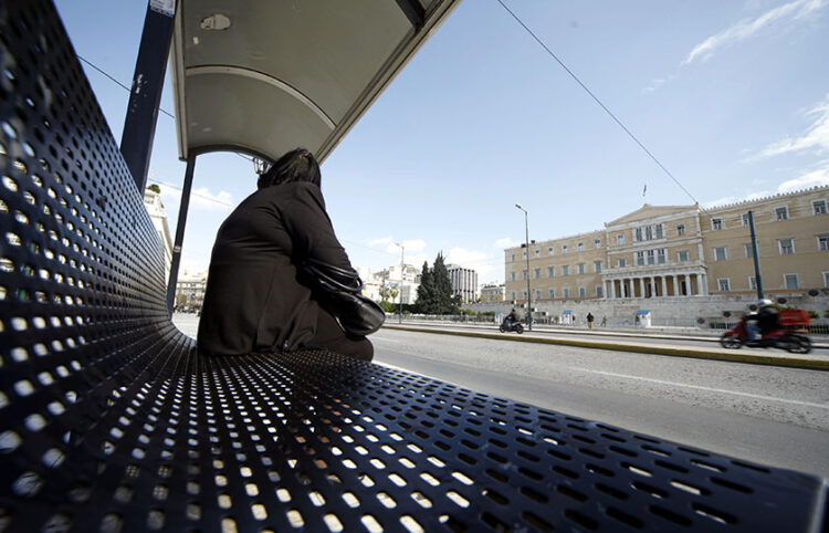 Γυναίκα περιμένει το λεωφορείο σε στάση στην πλατεία Συντάγματος  (φωτ.: EUROKINISSI / Γιώργος Κονταρίνης)