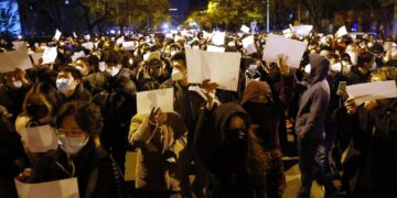 Πολίτες διαδηλώνουν στο Πεκίνο κρατώντας λευκές κόλλες χαρτί, στη διάρκεια διαμαρτυρίας για το θάνατο 10 ανθρώπων σε πυρκαγιά που ξέσπασε σε κτήριο στην πόλη Ουρούμτσι (φωτ.: EPA/Mark R. Cristino)