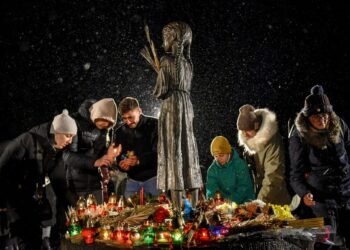 Ουκρανοί αφήνουν κεριά στο μνημείο του Χολοντομόρ, που σημαίνει η εξόντωση διά της πείνας στα ουκρανικά. (φωτ.: EPA/Oleg Petrasyuk)