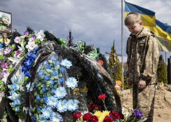 Ο 10χρονος Σεβέλιι στον τάφο του πατέρα του, ο οποίος σκοτώθηκε την 1η Μαΐου 2022 υπερασπιζόμενος το Ιρπίν (φωτ.: EPA / Mikhail Palinchak)