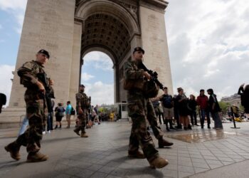 Γάλλοι στρατιώτες περιπολούν στην Αψίδα του Θριάμβου, στο Παρίσι μετά από άλλη μια νύχτα ταραχών στη Γαλλία, με αφορμή το θάνατο του 17χρονου Ναχέλ από αστυνομικά πυρά (φωτ.: EPA/Olivier Matthys)