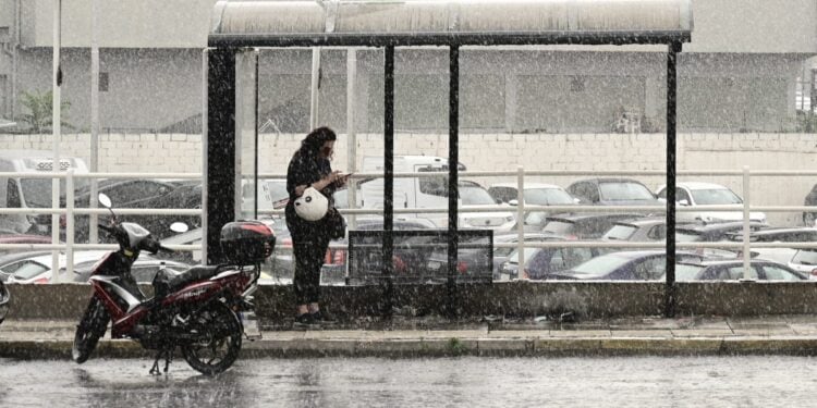 Οδηγός δικύκλου έχει σταματήσει σε στάση για να προφυλαχθεί από τη βροχή (φωτ. αρχείου: Eurokinissi/Μιχάλης Καραγιάννης)