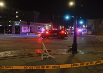 epa09597014 Police vehicles block an intersection where  crowds attending a Christmas parade along the route were strack by an SUV which reportedly broke through a barricade and drove into people including children, leaving multiple people dead and many more injured in Waukesha, Wisconsin, USA, 21 November 2021. The vehicle was recovered by police and a person of interest is in custody.  EPA/TANNEN MAURY
