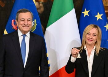 epa10260558 Italy's outgoing Prime Minister Mario Draghi (L) hands over the bell used by the cabinet president to manage cabinet debates to Prime Minister Giorgia Meloni (R) during the handover ceremony at Chigi Palace in Rome, Italy, 23 October 2022. Newly elected Prime Minister Giorgia Meloni and her cabinet were sworn in on 22 October.  EPA/ETTORE FERRARI