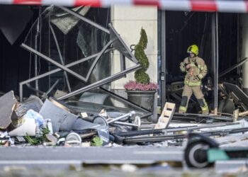 Έξω από το ξενοδοχείο, ένας σωρός από συντρίμμια βρίσκεται μπροστά από τις μπροστινές πόρτες, οι οποίες τώρα κρέμονται στο δρόμο (φωτ.: EPA/Filip Singer)