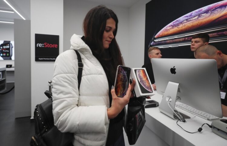 Νεαρή Ρωσίδα παίρνει περιχαρής το νέο iPhone στα χέρια της, στο κατάστημα της Apple, στη Μόσχα (φωτ. αρχείου: EPA/Sergei Ilnitsky)