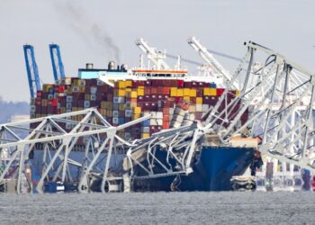 Ορισμένα από τα 47.000 εμπορευματοκιβώτια που κουβαλούσε το φορτηγό πλοίο, το οποίο παραμένει ακινητοποιημένο, φαίνονται να έχουν πάρει κλίση από την πρόσκρουση στον πυλώνα της γέφυρας. Δύο από αυτά έπεσαν στο νερό, ενώ τα αμπάρια του είναι γεμάτα με πετρέλαιο (φωτ.: EPA/Jim Lo Scalzo)