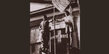 Μαθητές δημοτικού σχολείου στην Κύπρο κρατούν αυτοσχέδια ελληνική σημαία, που ανάρτησαν στο σχολείο τους παρά τη σχετική αυστηρή απαγόρευση (φωτ.: Ίδρυμα Απελευθερωτικού Αγώνα ΕΟΚΑ 1955-1959)