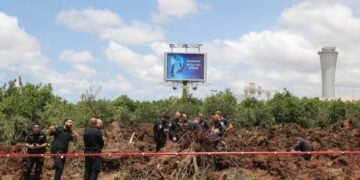 Αστυνομικοί εξετάζουν τον κρατήρα που άνοιξε ο πύραυλος όταν κατέπεσε δίπλα στο αεροδρόμιο Μπεν Γκουριόν (φωτ.: EPA/Abir Sultan)