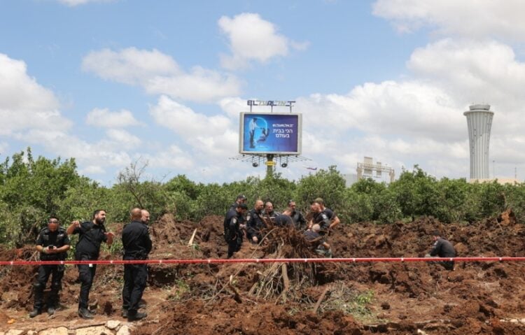 Αστυνομικοί εξετάζουν τον κρατήρα που άνοιξε ο πύραυλος όταν κατέπεσε δίπλα στο αεροδρόμιο Μπεν Γκουριόν (φωτ.: EPA/Abir Sultan)