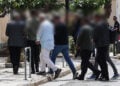 Οι 9 συλληφθέντες κατά τη μεταγωγή τους στον εισαγγελέα 
(φωτ.: EUROKINISSI / Γιάννης Παναγόπουλος)