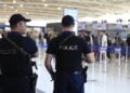 Κύπριοι αστυνομικοί στο αεροδρόμιο της Λάρνακας φρουρούν Ισραηλινούς που ετοιμάζονται να αναχωρήσουν για τη Χάιφα (φωτ.: EPA/Alex Mita)