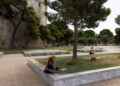 Γυναίκα κάθεται κάτω από τη σκιά ενός δέντρου ώστε να προστατευτεί από τις υψηλές θερμοκρασίες και τον καυτό ήλιο, Θεσσαλονίκη (φωτ.: ΑΠΕ-ΜΠΕ / Αχιλλέας Χήρας)