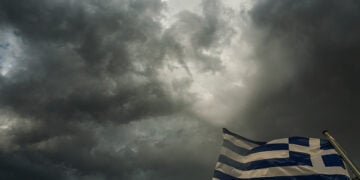 Ελληνική σημαία ανεμίζει με φόντο σύννεφα καταιγίδας στην πόλη των Τρικάλων (φωτ.: EUROKINISSI / Θανάσης Καλλιάρας)