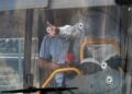 Τρύπες από σφαίρες διακρίνονται στο παρμπρίζ λεωφορείου (φωτ.: EPA/Abir Sultan)
