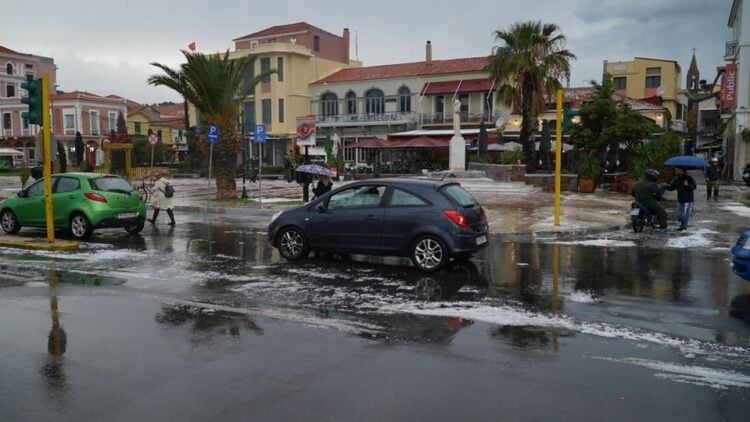 Κόσμος περπατά κρατώντας ομπρέλες, κατά τη διάρκεια της κακοκαιρίας με ισχυρή χαλαζόπτωση και βροχοπτώσεις στη Μυτιλήνη (φωτ.: ΑΠΕ-ΜΠΕ/ΗΛΙΑΣ ΜΑΡΚΟΥ)
