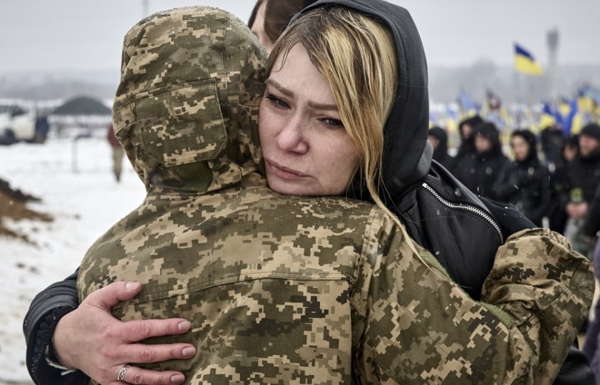 Συγγενείς και στρατιώτες αγκαλιάζονται στη διάρκεια επιμνημόσυνης δέησης στο Χάρκοβο για τους πεσόντες στον πόλεμο (φωτ.: EPA/Sergey Kozlov)