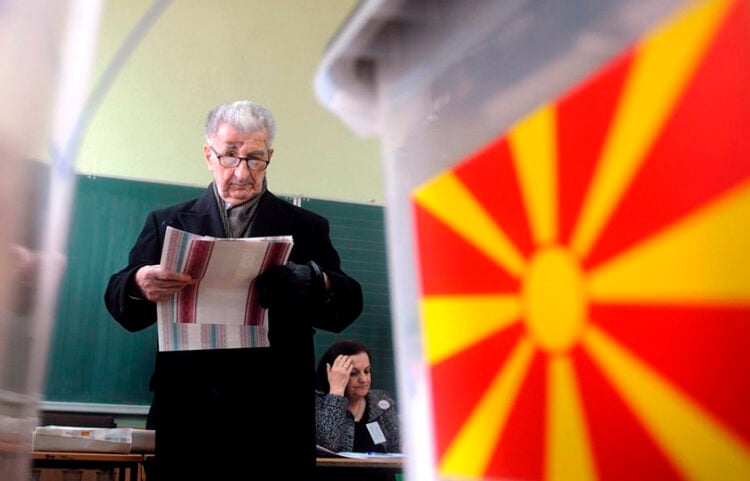 Ο Κίρο Γκλιγκόροφ με ψηφοδέλτια στα χέρια, σε εκλογικό κέντρο στα Σκόπια, 22 Μαρτίου 2009 (φωτ.: EPA / Georgi Licovski)