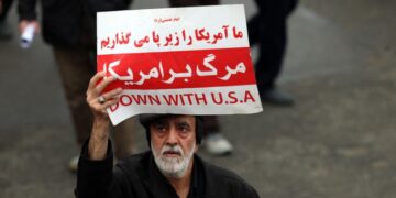 Ιράνος κρατά πανό που γράφει «Κάτω οι ΗΠΑ» στη διάρκεια κηδείας αξιωματούχου του καθεστώτος στην Τεχεράνη (φωτ.: EPA/Abedin Taherkenareh)