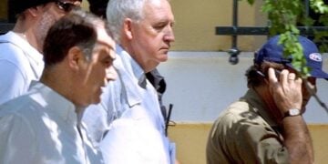 Ο Αλέξανδρος Γιωτόπουλος οδηγείται στο γραφείο του εισαγγελέα για απολογία, 23 Ιουλίου 2002 (φωτ.: ΑΠΕ-ΜΠΕ / Συμέλα Παντζαρτζή)