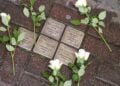 Λευκά τριαντάφυλλα σε «Stolpersteine» (λιθόστρωτα μνήμης), στο Ντόρστεν της Γερμανίας (φωτ. αρχείου: EPA/ Christopher Neundorf)