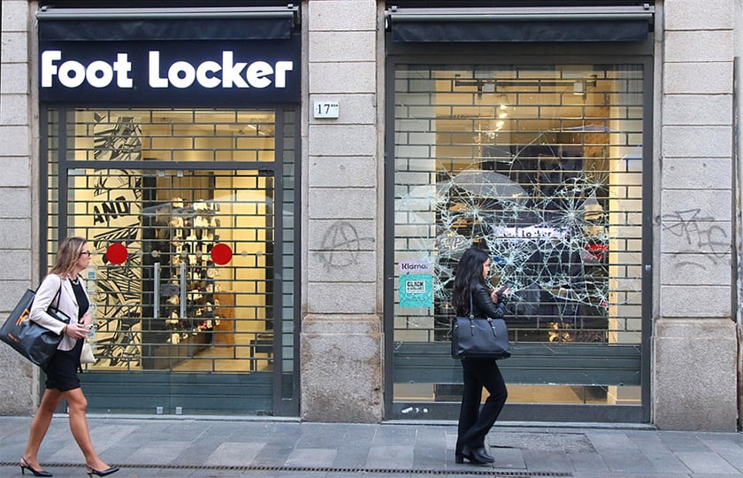 Περαστικοί μπροστά σε σπασμένη βιτρίνα καταστήματος στο Μιλάνο, στις 19 Οκτωβρίου 2026 (φωτ.: EPA / Paolo Salmoirago)